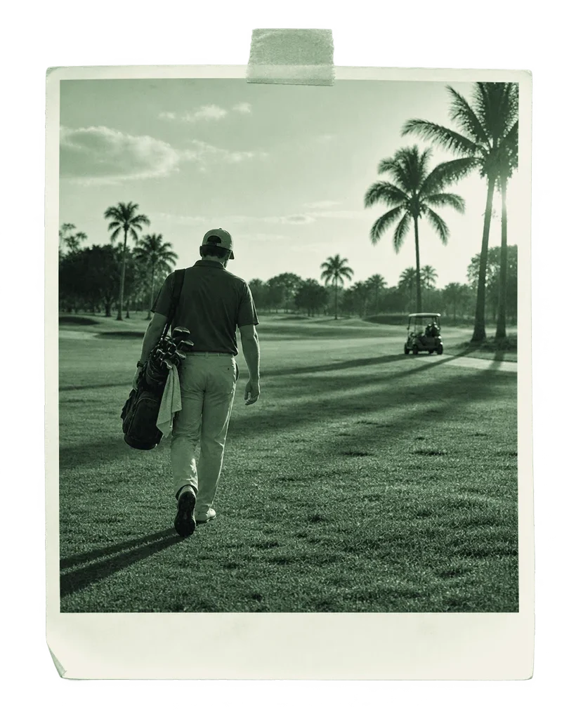 A golfer walking a Miami fairway at low sun, palms along the treeline